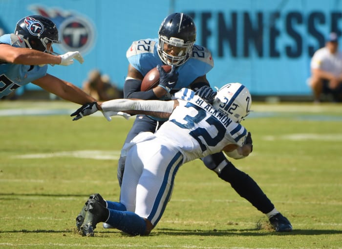 Sep 26, 2021; Nashville, Tennessee, USA; Tennessee Titans running back Derrick Henry (22) and Indianapolis Colts safety Julian Blackmon (32) during the second half during the second half at Nissan Stadium.